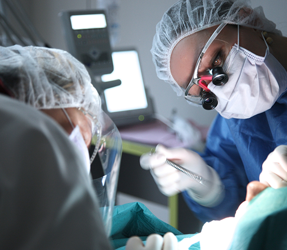 Dentist and assistant performing a dental procedure on a patient