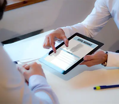 Patient reviewing dental insurance form on tablet