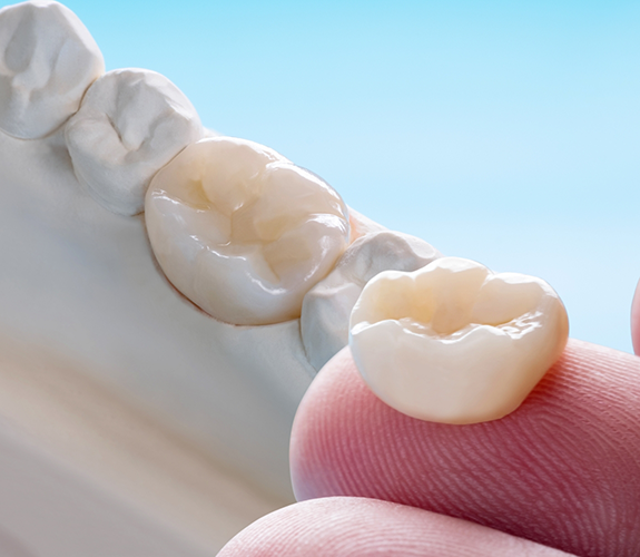 Close up of a dental crown on a finger