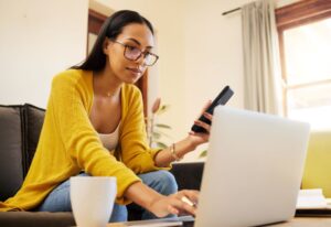 Woman using her laptop to shop for dental insurance 
