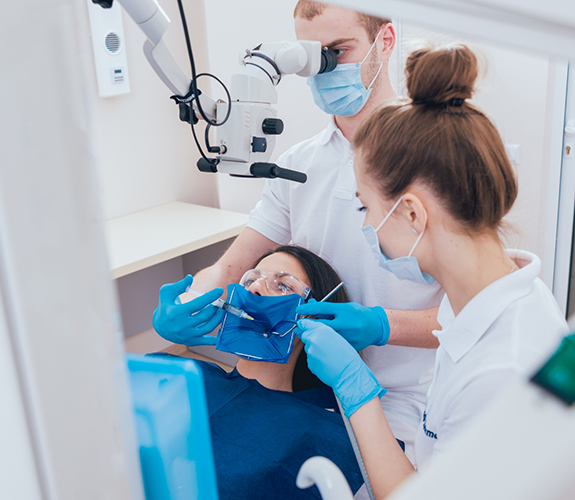 Patient in the dental chair receiving professional teeth whitening